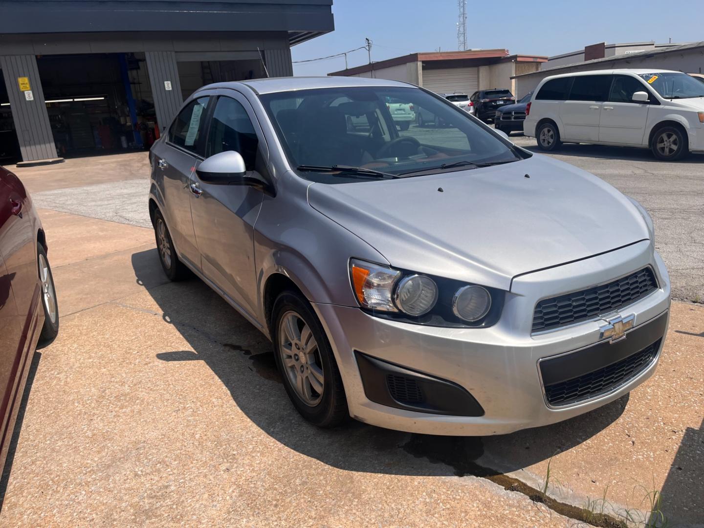 2013 SILVER Chevrolet Sonic LT Auto Sedan (1G1JC5SHXD4) with an 1.8L L4 DOHC 24V FFV engine, 6-Speed Automatic transmission, located at 8101 E. Skelly Dr., Tulsa, OK, 74129, (918) 592-3593, 36.121891, -95.888802 - Photo#1